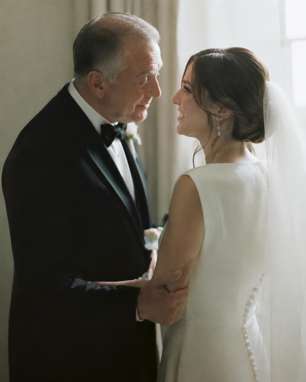 A bride sharing a quiet moment with her father before the ceremony